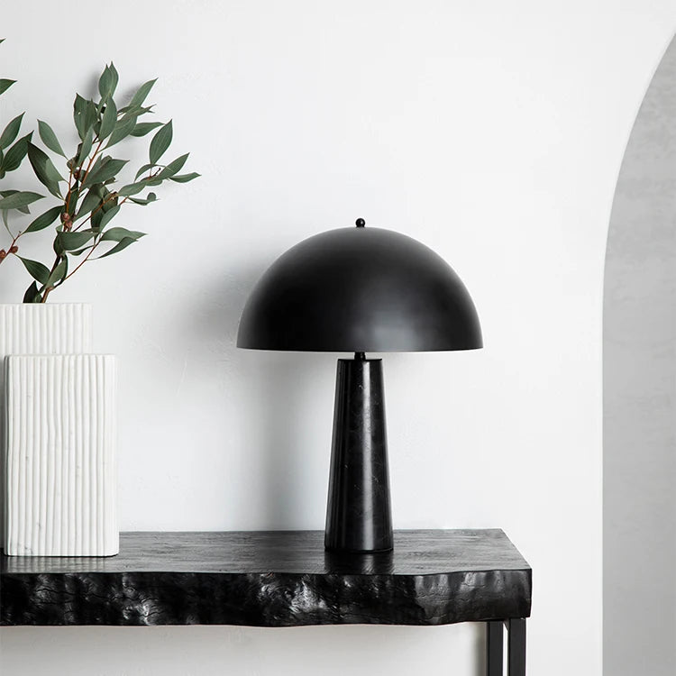 A domed table lamp with a brass shade and marble stand from Sage and Wyld.